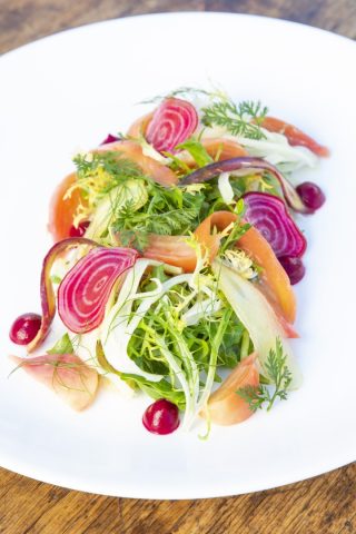 Fresh vegetable salad with colorful beets, radishes, and greens.
