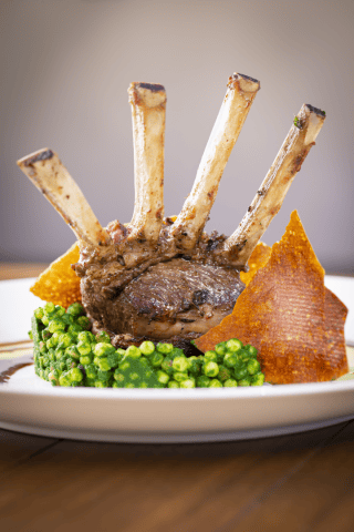 Delicious lamb chops served with green peas and crispy sweet potato chips at La Quinta Resort & Club.