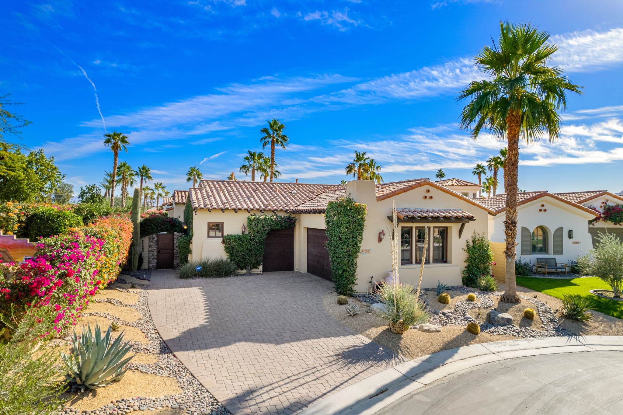 Exterior view of La Quinta Resort & Club with palm trees and desert landscaping.