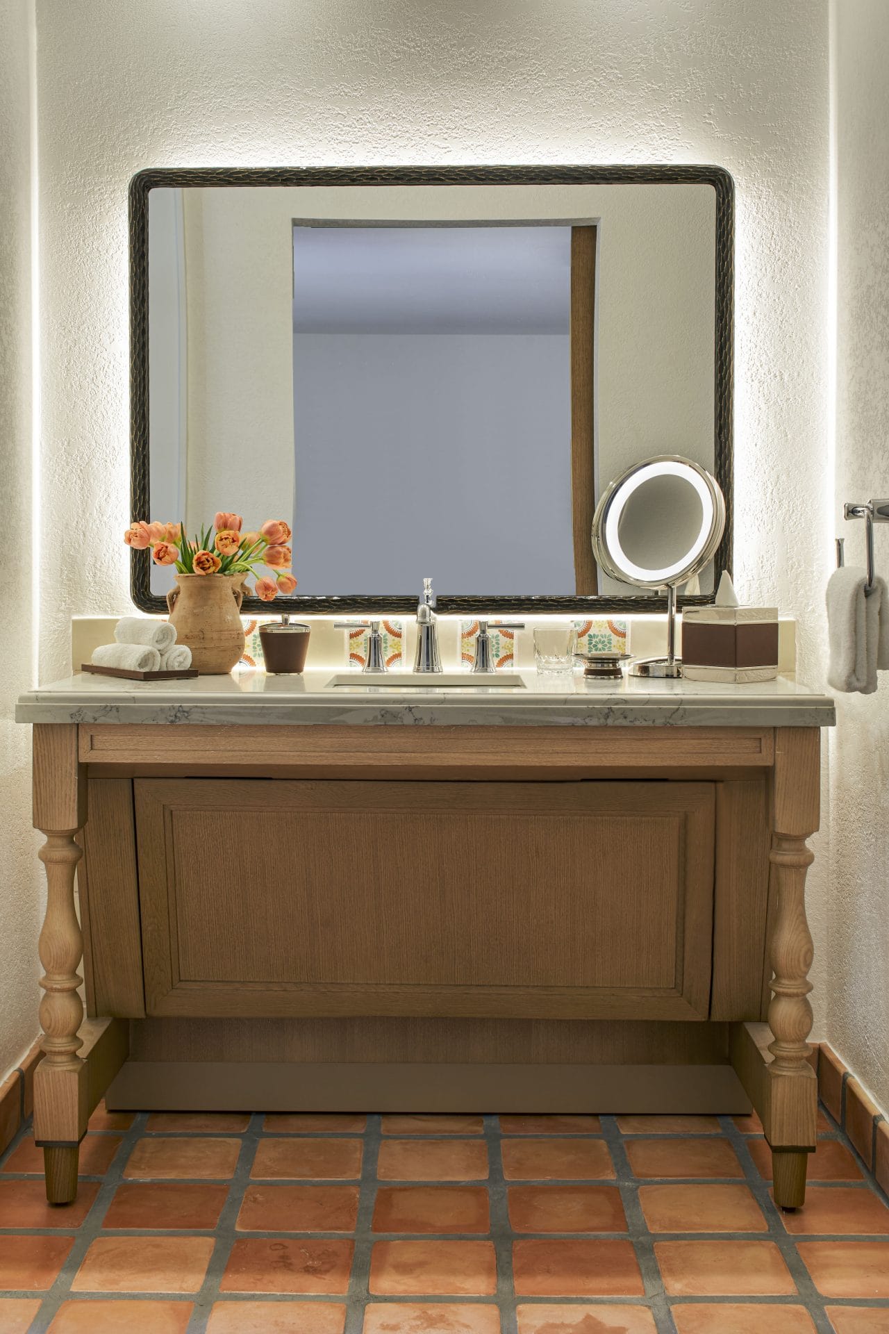 Accessible bathroom with roll-in shower, hearing notification devices, and modern vanity at La Quint.