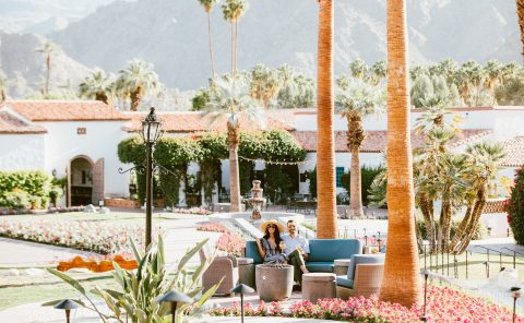 Beautiful outdoor seating area at La Quinta Resort & Club with palm trees and mountain views.