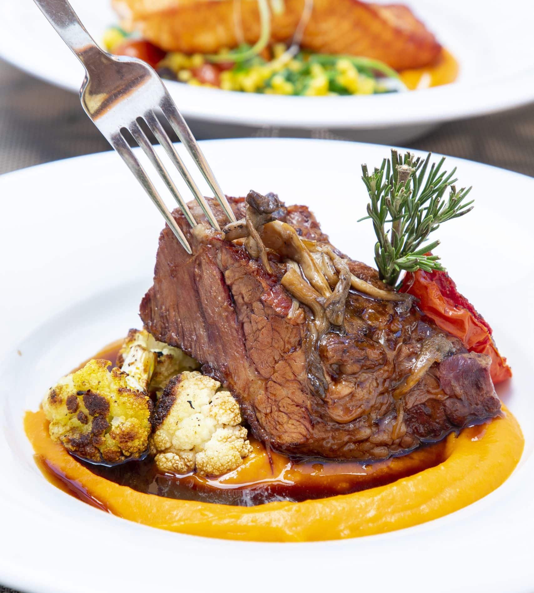 Juicy steak with vegetables and sauce at La Quinta Resort & Club.