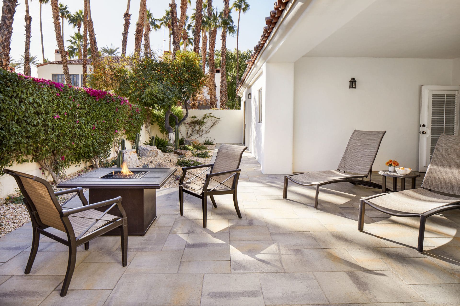 Spacious outdoor patio with lounge chairs and fire pit at La Quinta Resort & Club.