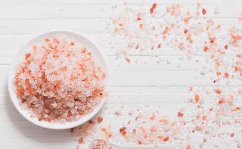 Pink Himalayan salt crystals on white wooden surface at La Quinta Resort & Club.