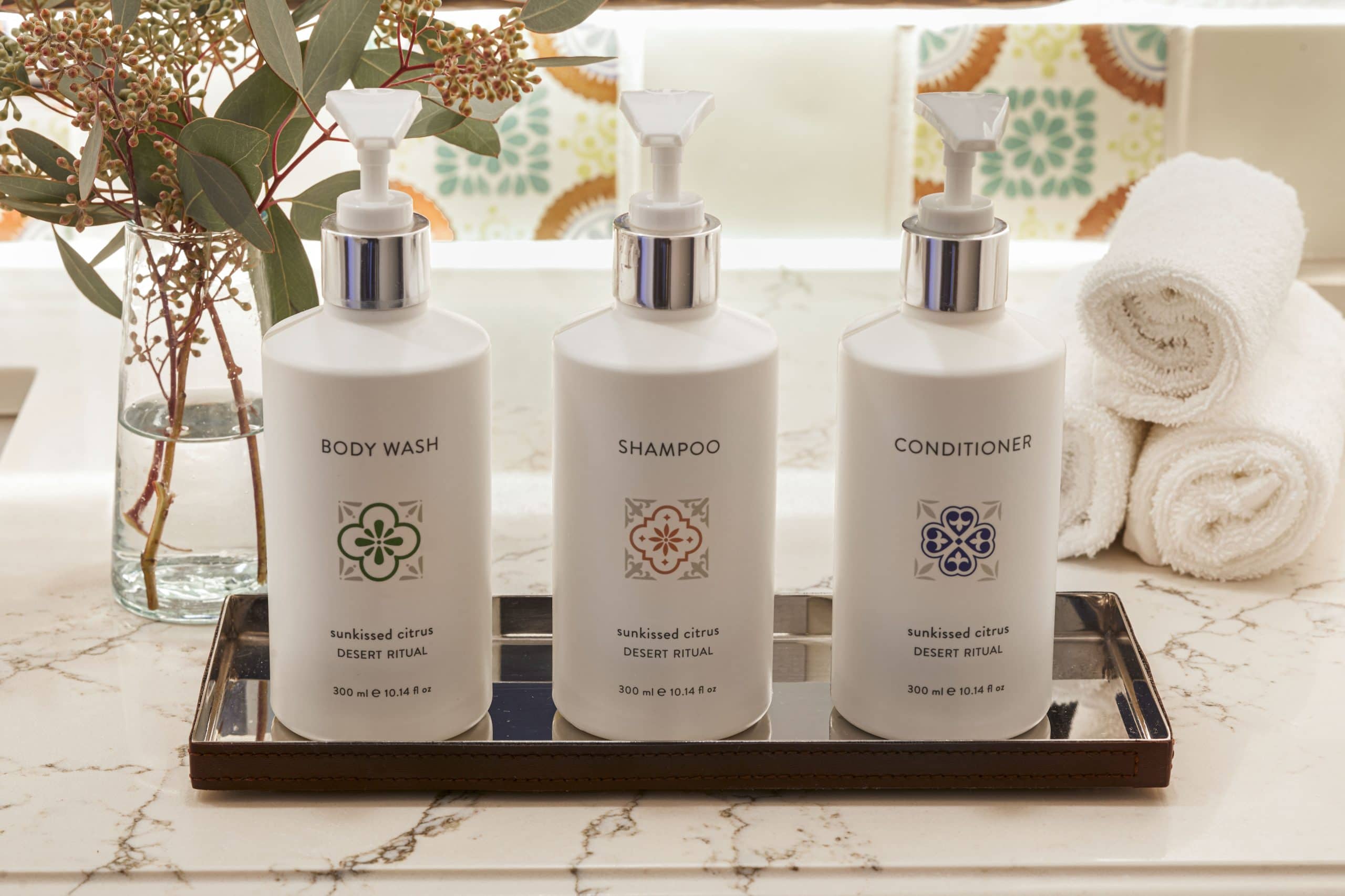 Elegant bathroom amenities with body wash, shampoo, and conditioner bottles.