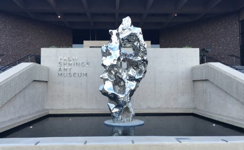 Elegant metallic sculpture displayed at Palm Springs Art Museum entrance.