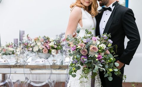 Beautiful wedding couple holding a bouquet at La Quinta Resort & Club.