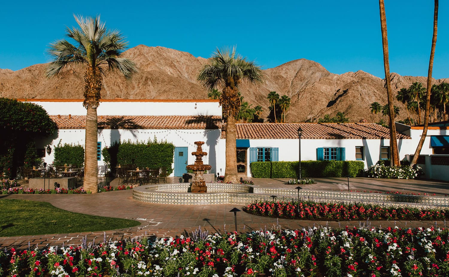 Beautiful view of La Quinta Resort with mountains, palm trees, and lush gardens.