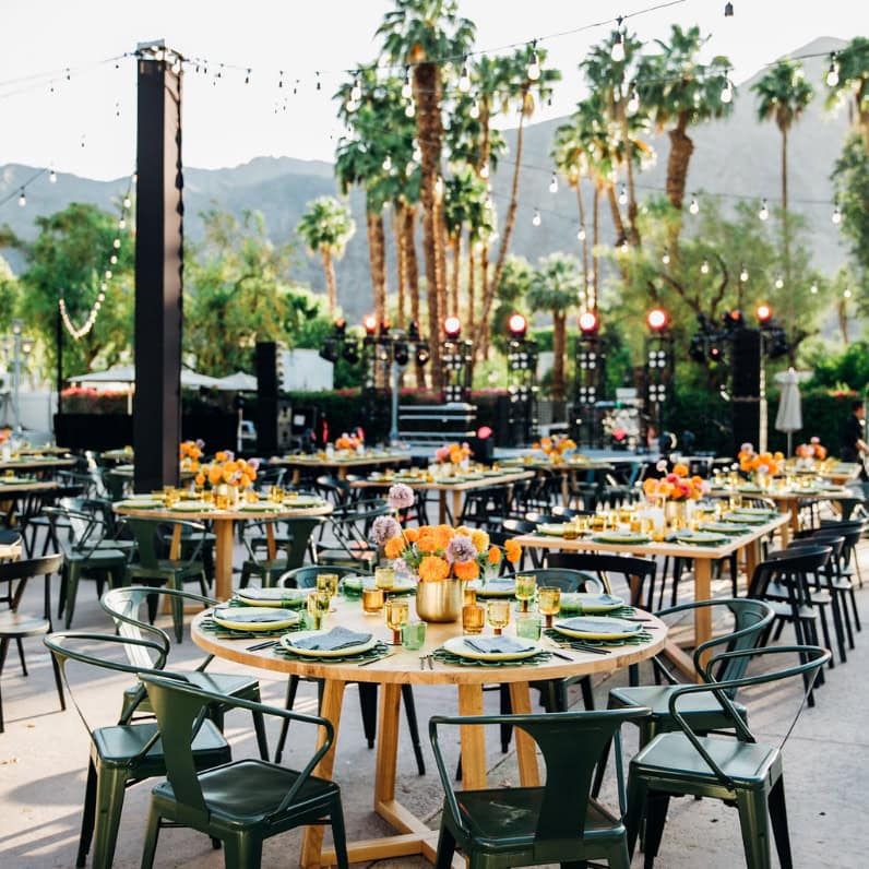 Outdoor meeting area at La Quinta Resort with tables and palm trees.