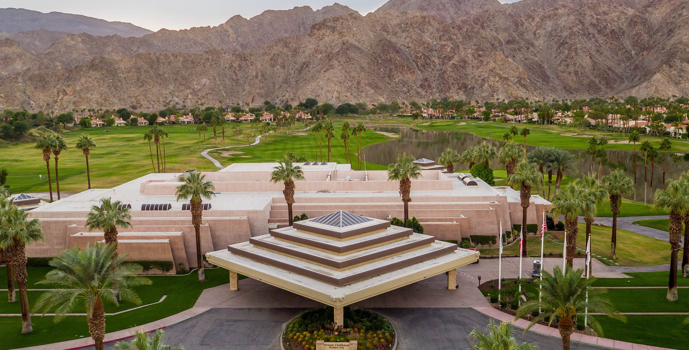 Elegant clubhouse at La Quinta Resort & Club with lush gardens and mountain views.