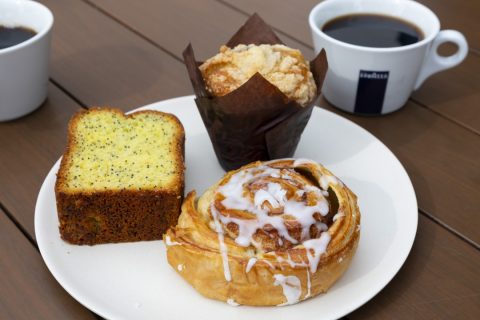 Delicious cinnamon roll with icing served alongside coffee at The Marketplace, La Quinta Resort & Cl.