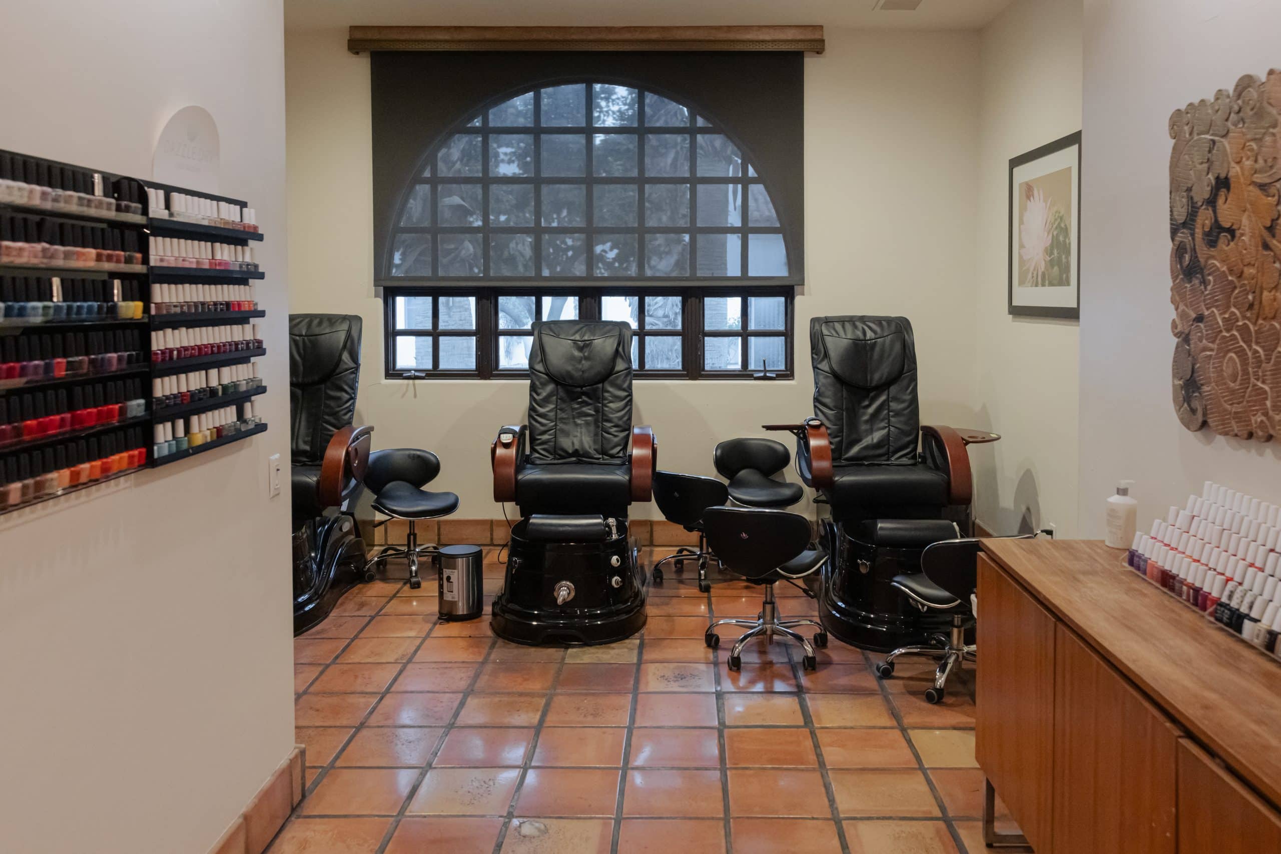 Spa La Quinta nail and skin care treatment room with massage chairs and products.