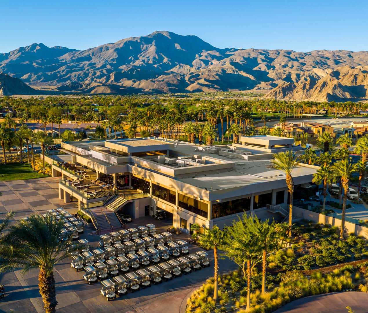 Aerial view of La Quinta Resort & Club clubhouses with mountains in background.