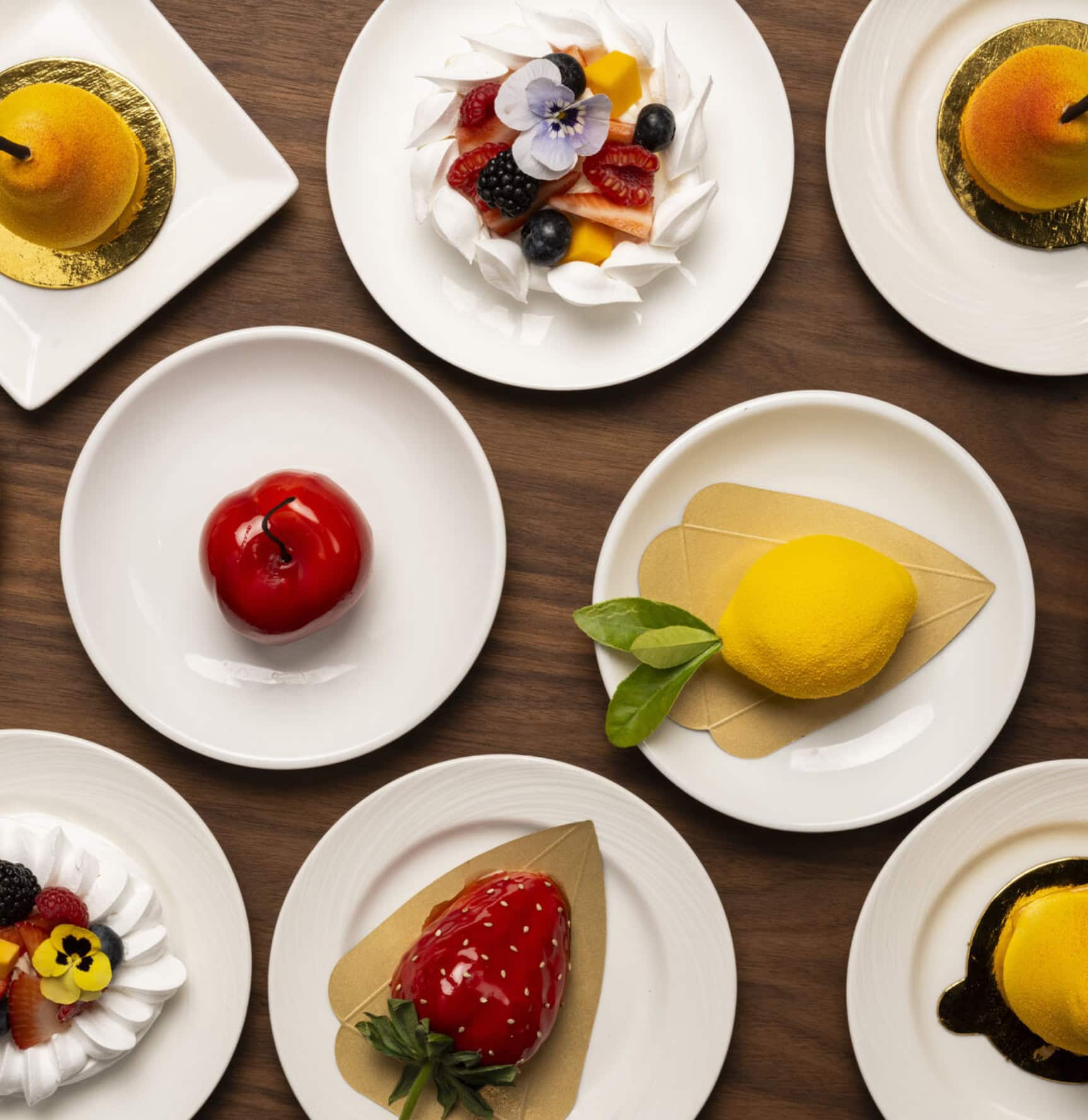 Delicious fruit desserts served on white plates at La Quinta Resort & Club. Fresh berries, lemon, an.