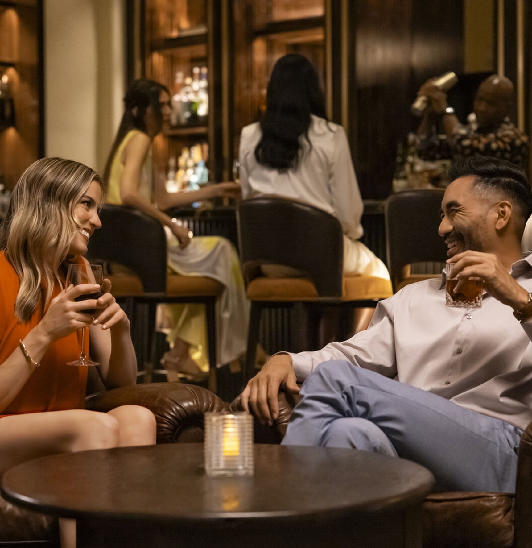 Elegant resort lounge with guests enjoying drinks and conversation.