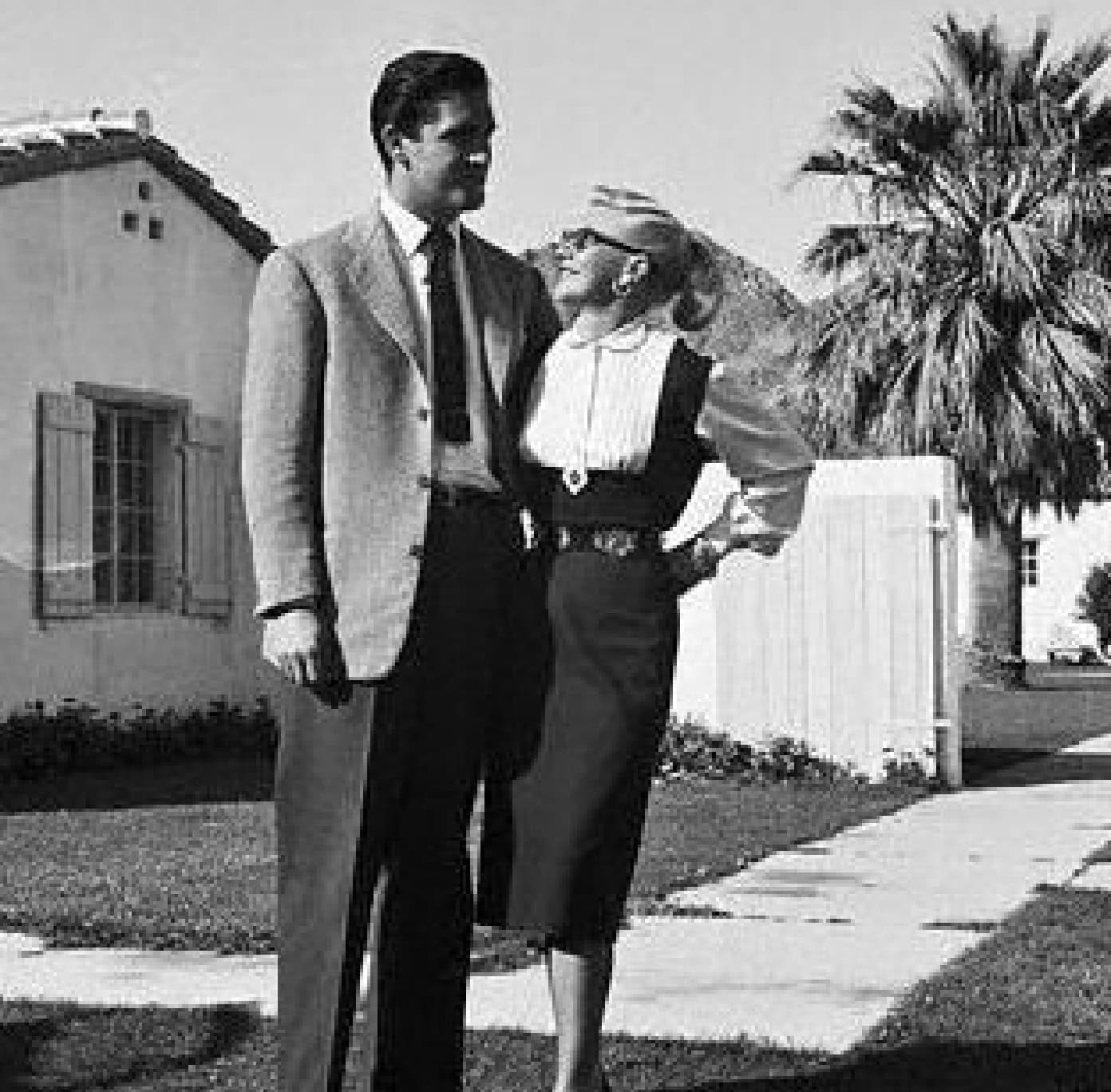 Vintage couple walking outdoors at La Quinta Resort & Club, Palm Springs, California.