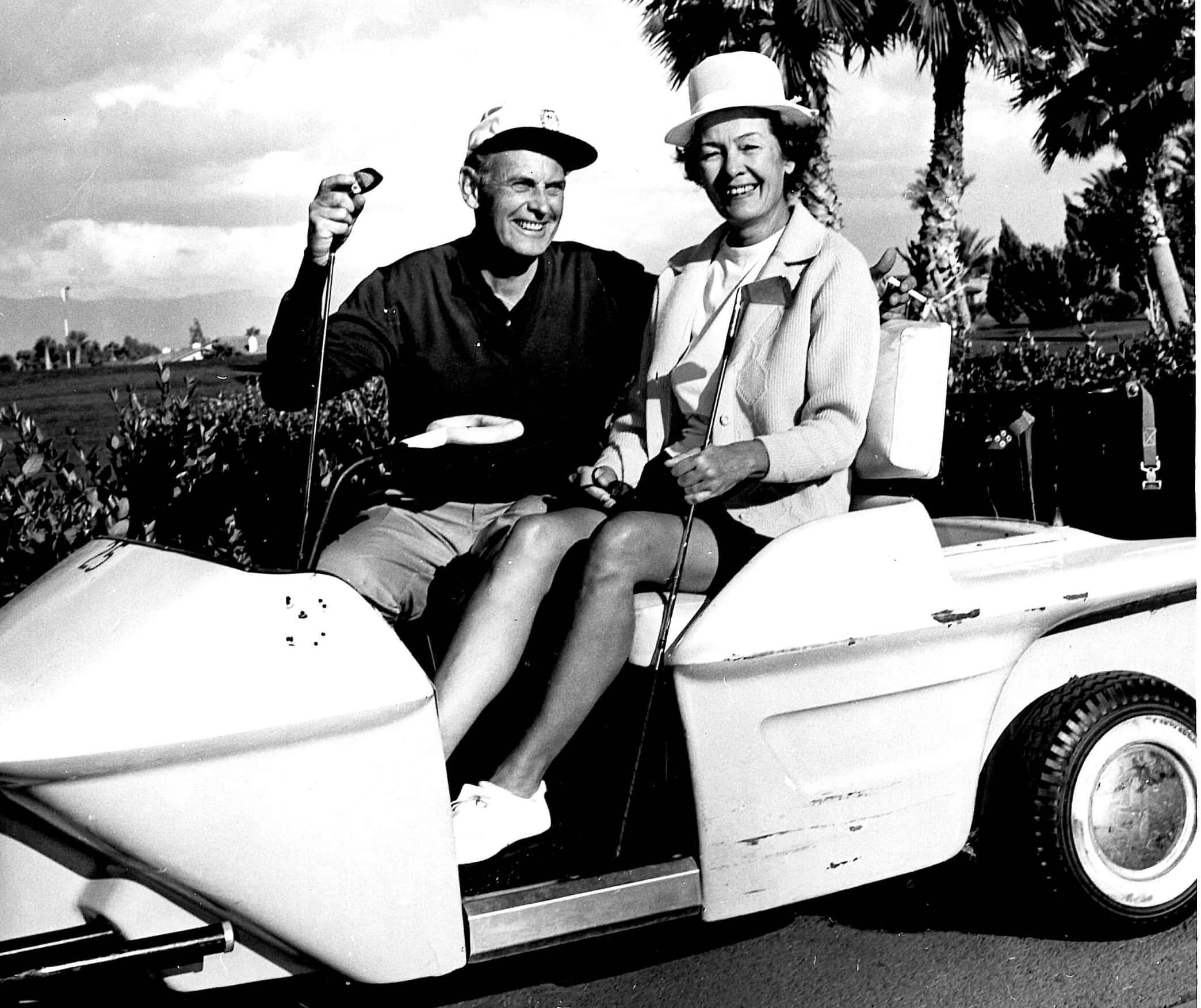 Vintage golf cart with smiling couple, Palm Springs.