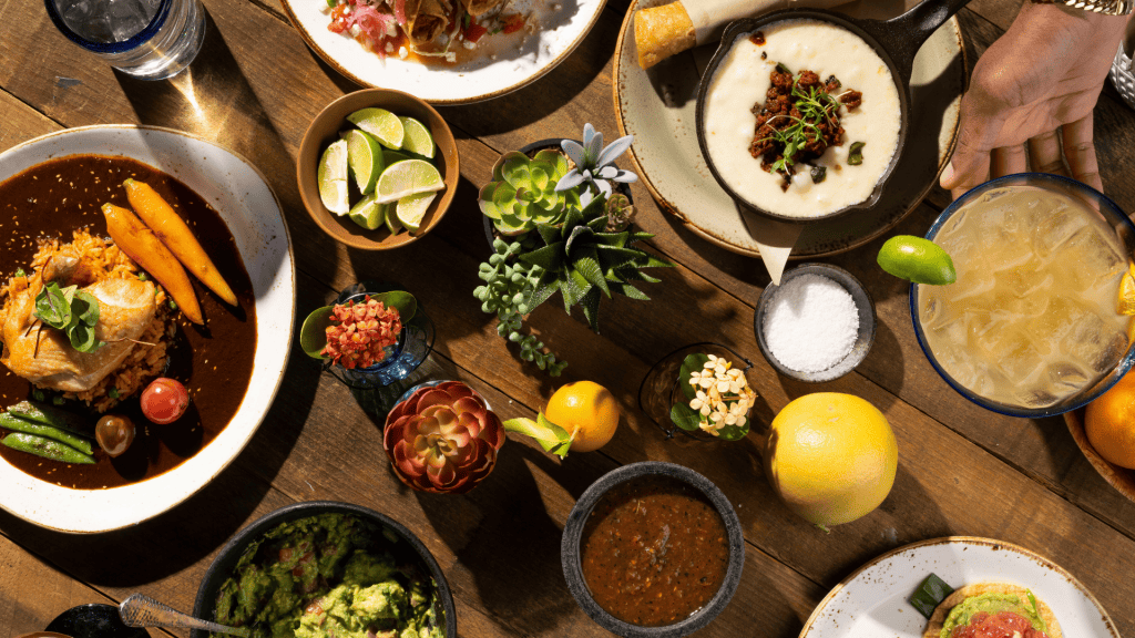 Elegant table setting with gourmet dishes and fresh ingredients.