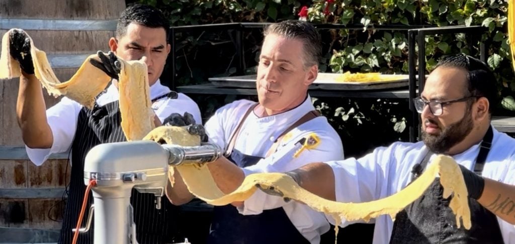 Chefs preparing festive churros at La Quinta Resort & Club during Christmas event.