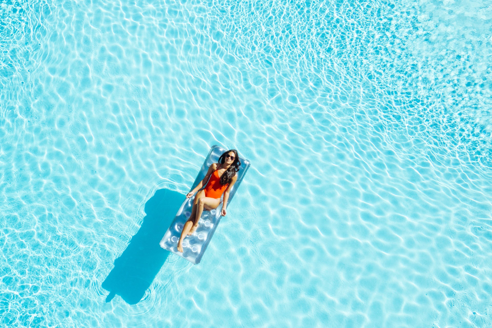 Woman relaxing on a float in the luxurious La Quinta Resort pool during spring break.