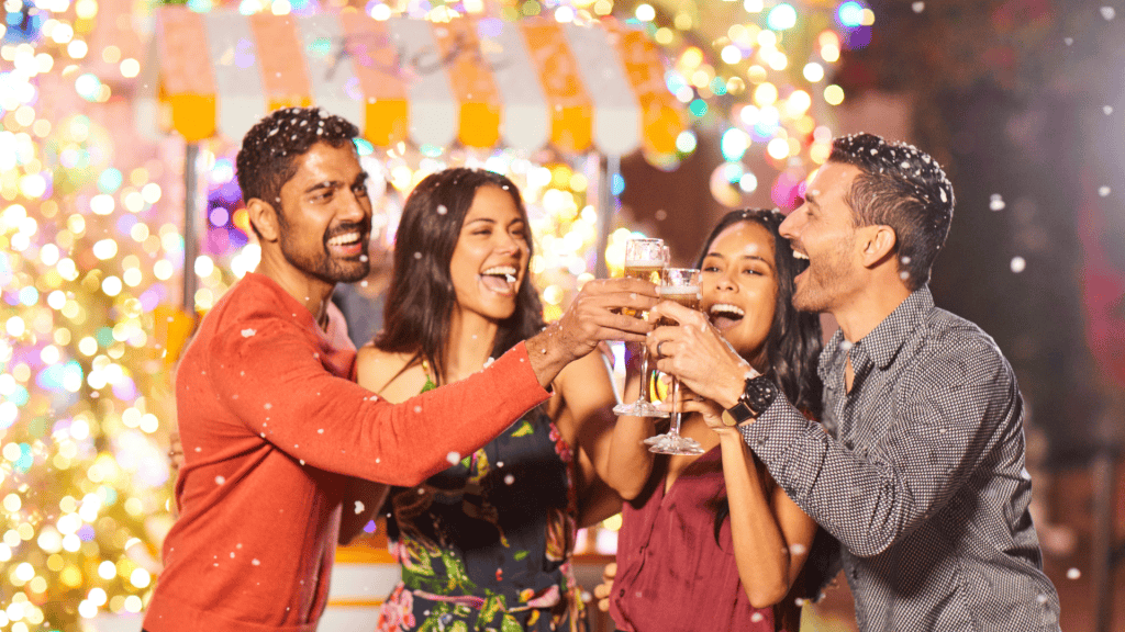 Group of friends celebrating at La Quinta Resort & Club with festive lights in the background.