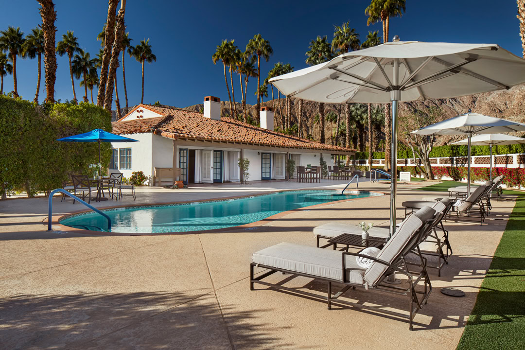 Luxurious outdoor pool at La Quinta Resort & Club with lounge chairs and umbrellas.