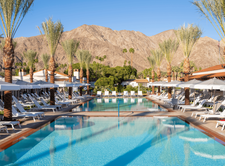 Luxury resort pool at La Quinta Resort with mountain backdrop and palm trees.