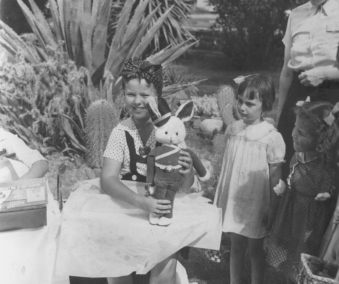 Children celebrating a birthday with a bunny toy outdoors at La Quinta Resort.