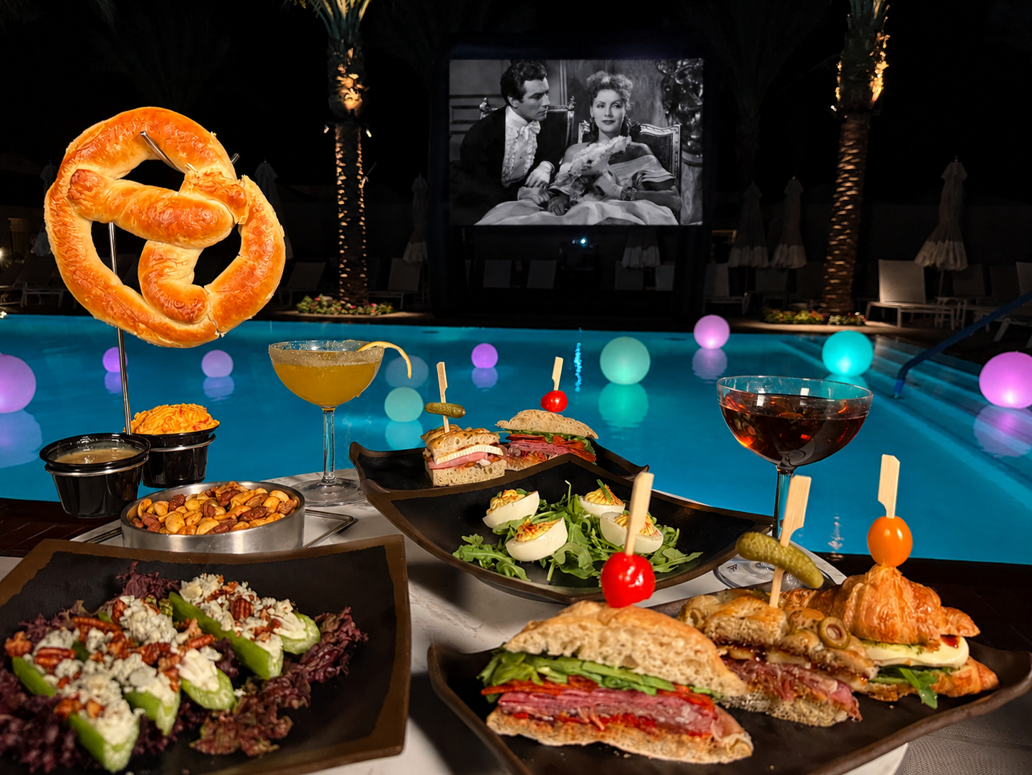 Poolside dining with snacks, drinks, and a movie at La Quinta Resort.