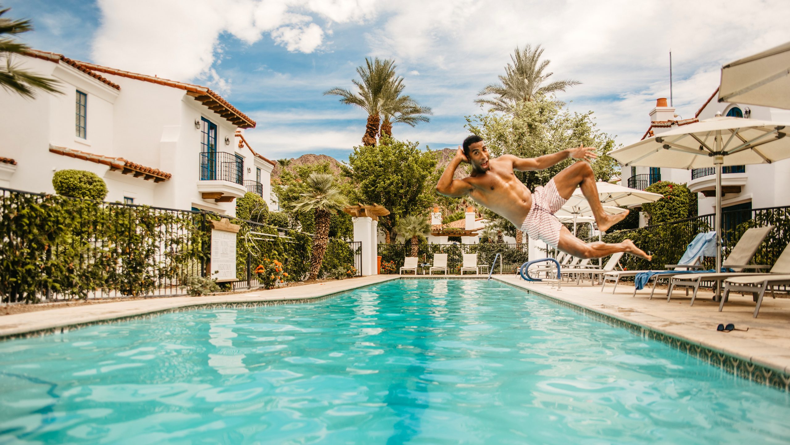 Man jumping into the pool at La Quinta Resort & Club, California.