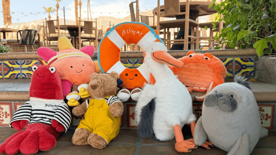 Assorted plush toys including a crab, pelican, and bear at La Quinta Resort poolside.
