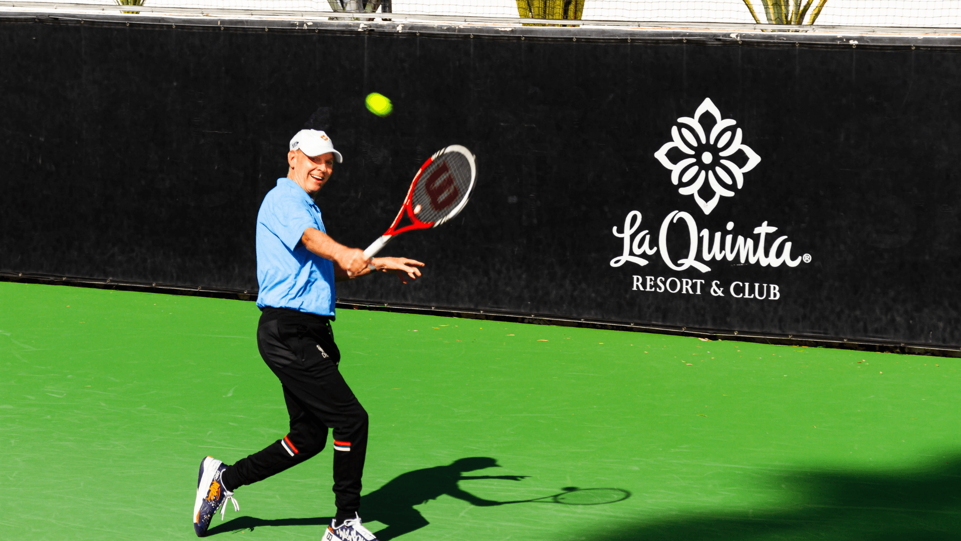 Tennis player holding a tennis ball and racket at La Quinta Resort & Club.