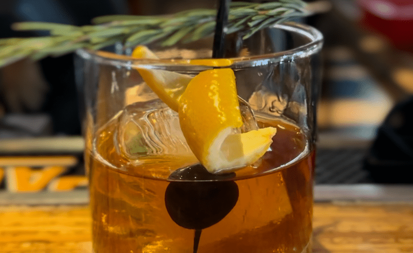 Close-up of a cocktail with lemon and cherry garnish at La Quinta Resort.