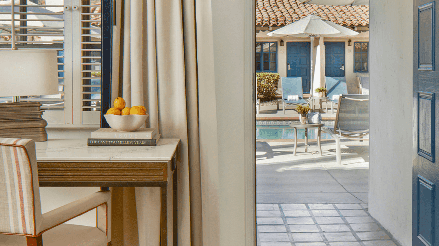 Poolside view at La Quinta Resort & Club with outdoor seating and umbrellas.