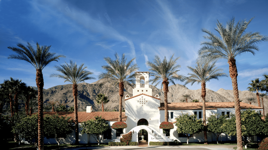 Scenic view of La Quinta Resort with palm trees and mountains in the background.