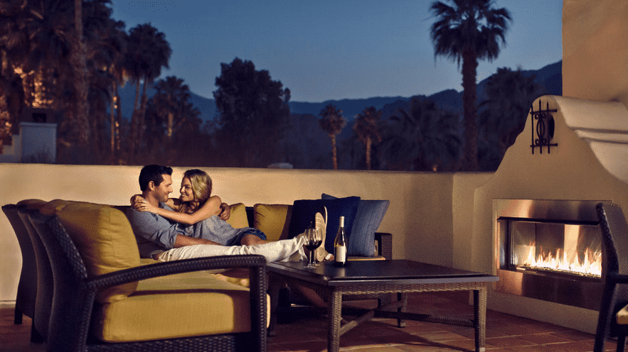 Couple enjoying a cozy evening by the fireplace at La Quinta Resort & Club.
