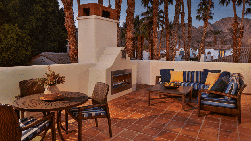 Outdoor lounge area at La Quinta Resort with seating and fireplace.