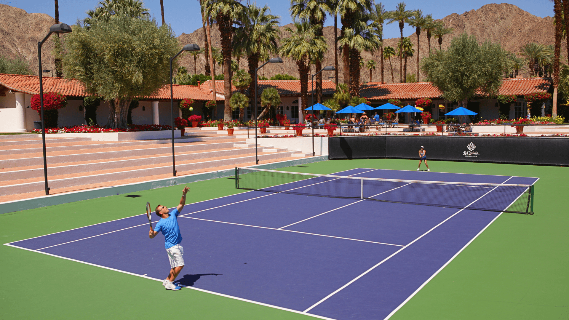 Tennis player hitting ball on outdoor court at La Quinta Resort & Club.
