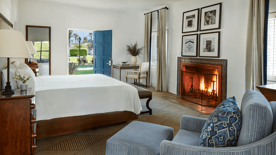 Luxurious bedroom with fireplace and classic decor at La Quinta Resort.