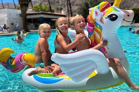 Children enjoying a colorful unicorn float in the pool at La Quinta Resort.