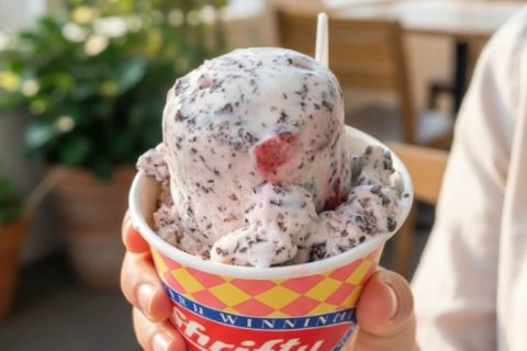 Close-up of cookies and cream ice cream in a colorful cup.