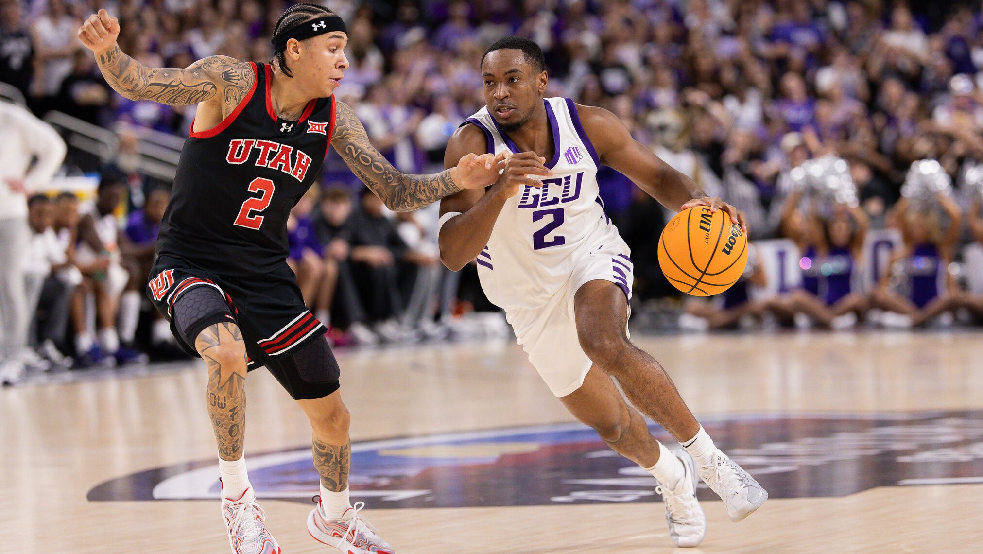 Two players competing for the basketball during a college game at La Quinta.