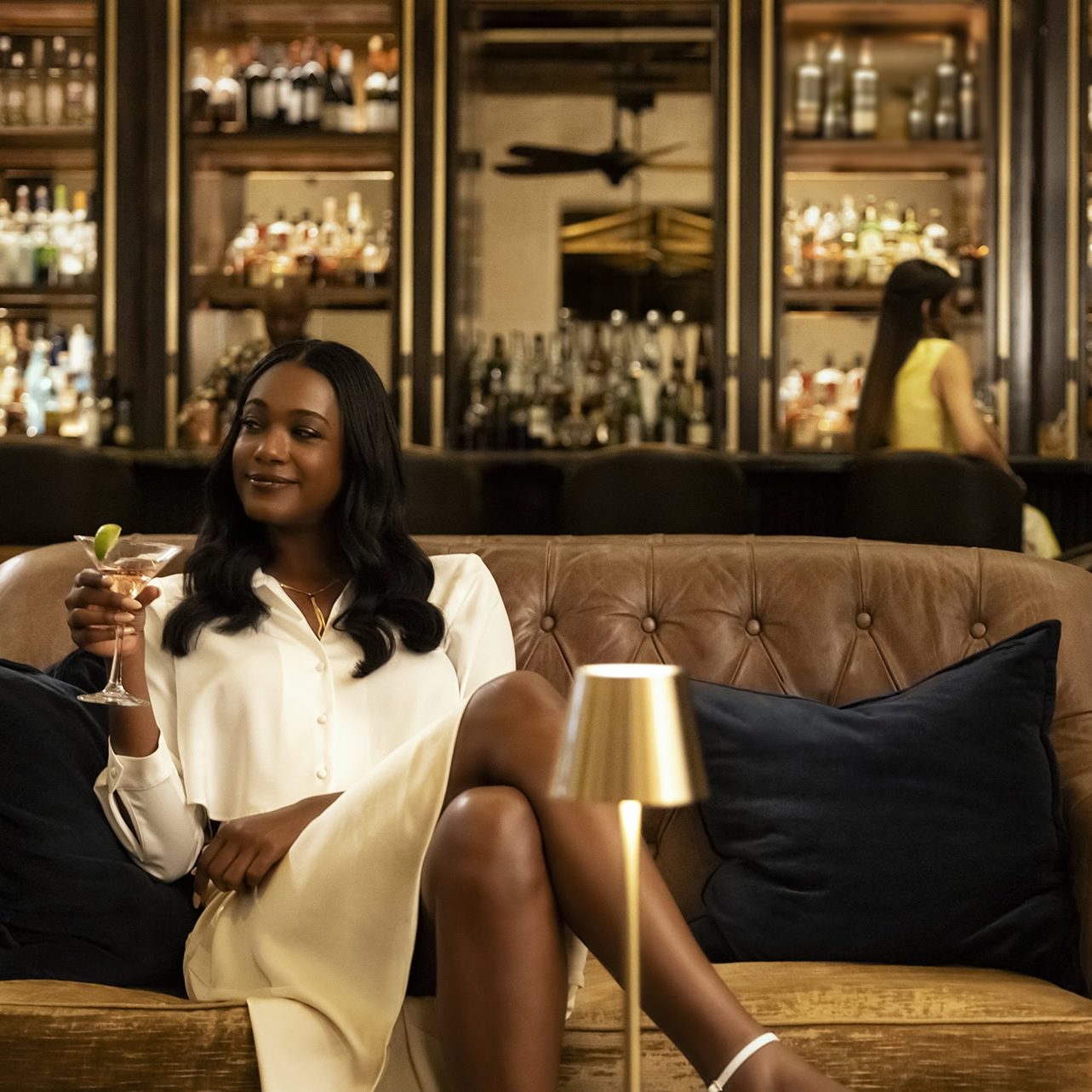 Woman enjoying a cocktail in a luxurious lounge at La Quinta Resort & Club during spring break.
