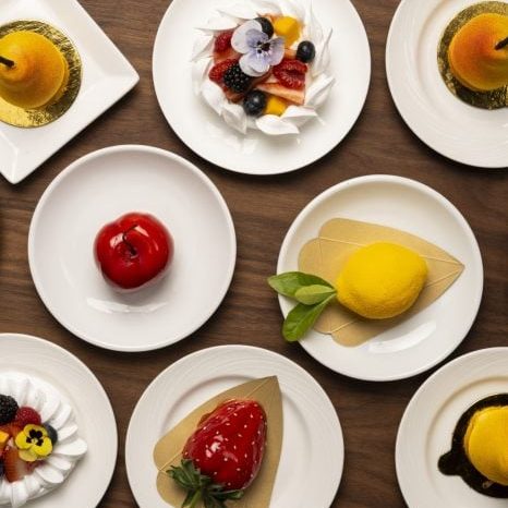 Delicious fruit desserts served on white plates at La Quinta Resort & Club. Fresh berries, lemon, an.