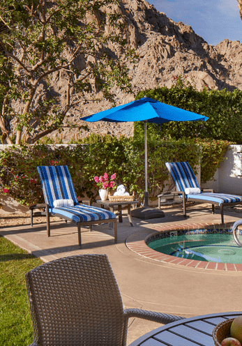 Relaxing pool area at La Quinta Resort with lounge chairs and umbrellas.