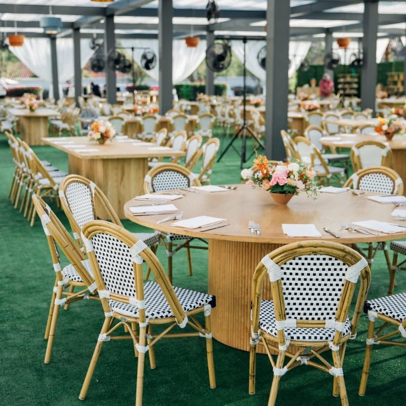 Elegant outdoor meeting setup with round tables and floral centerpieces at La Quinta Resort.