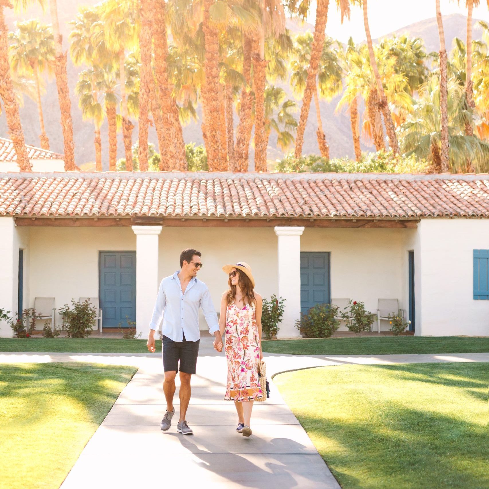 Couple walking at La Quinta Resort with palm trees in the background.