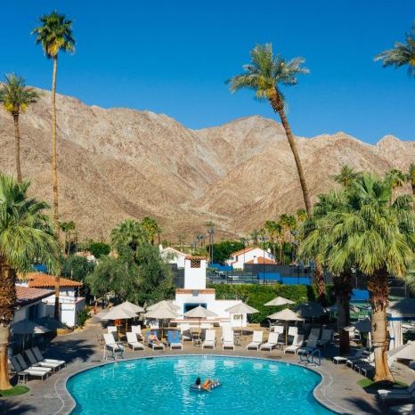 Pool at La Quinta Resort with palm trees and mountains in the backdrop.